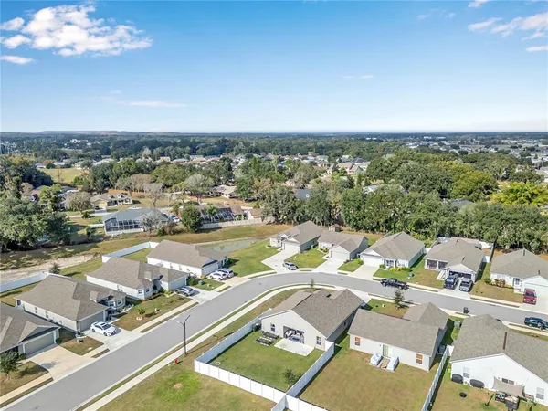 an aerial view of a swimming pool with a city view