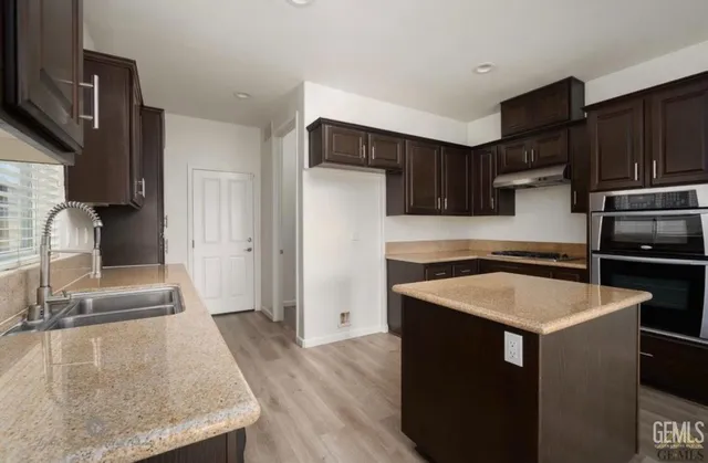 a kitchen with a sink stove and refrigerator