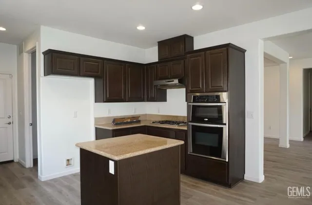 a kitchen with wooden cabinets and stainless steel appliances