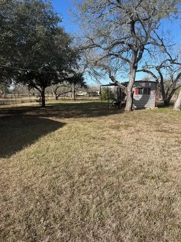 a view of dirt road with a building