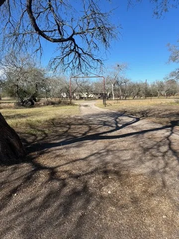 a view of a yard with wooden fence