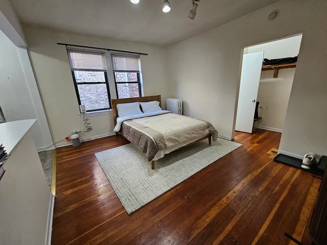 a living room with a bed furniture and a window