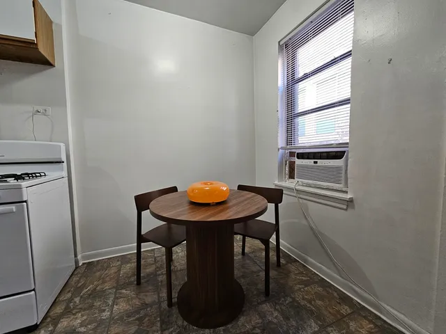 a view of a room that has a table and chair