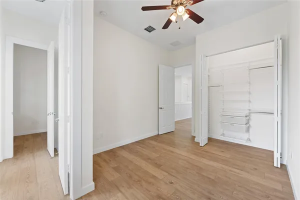 a view of empty room with wooden floor