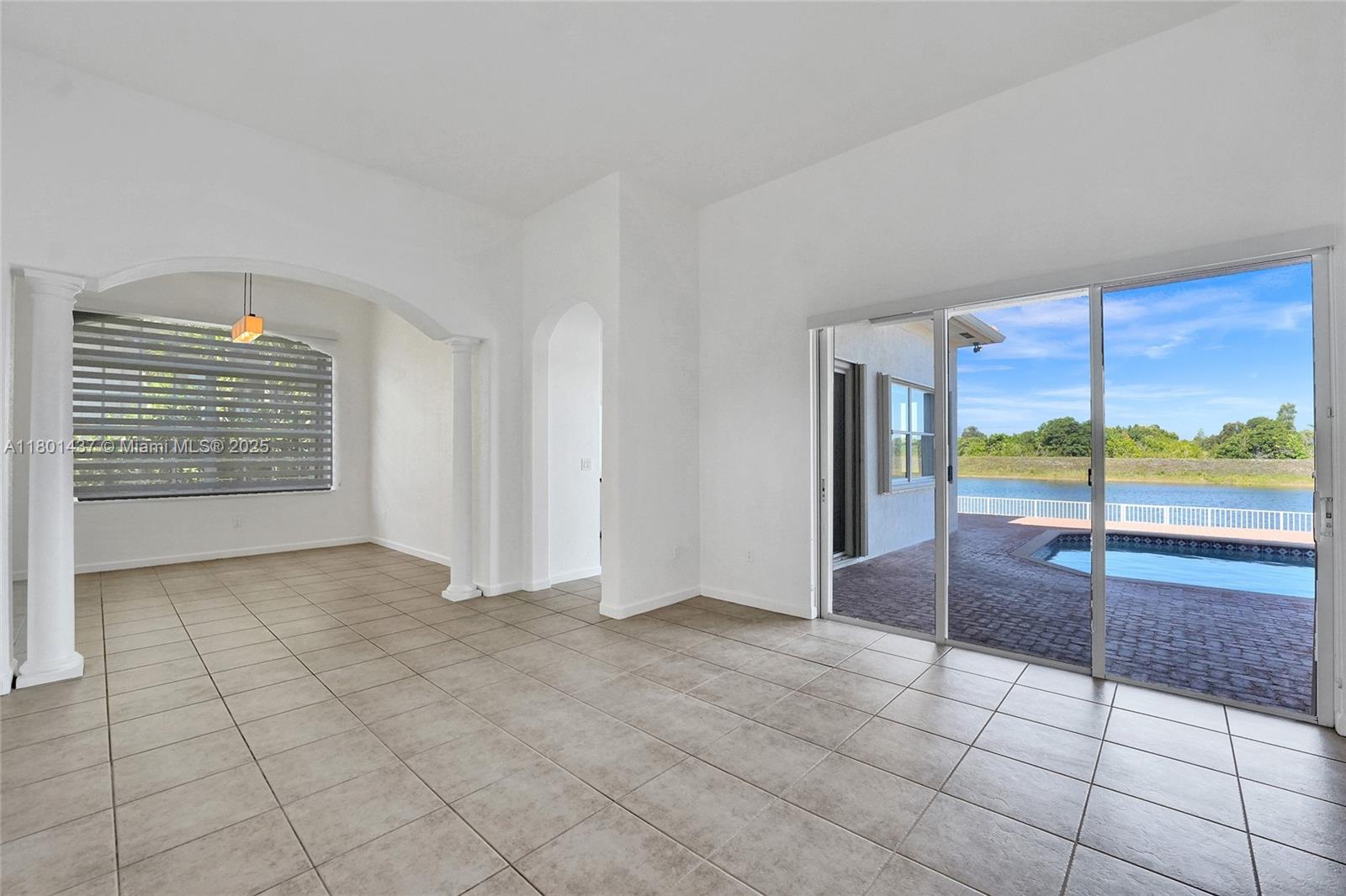 3360 Southwest 195th Terrace Miramar, FL 33029 - Photo 14 of 65 an empty room with floor to ceiling window and an outdoor view