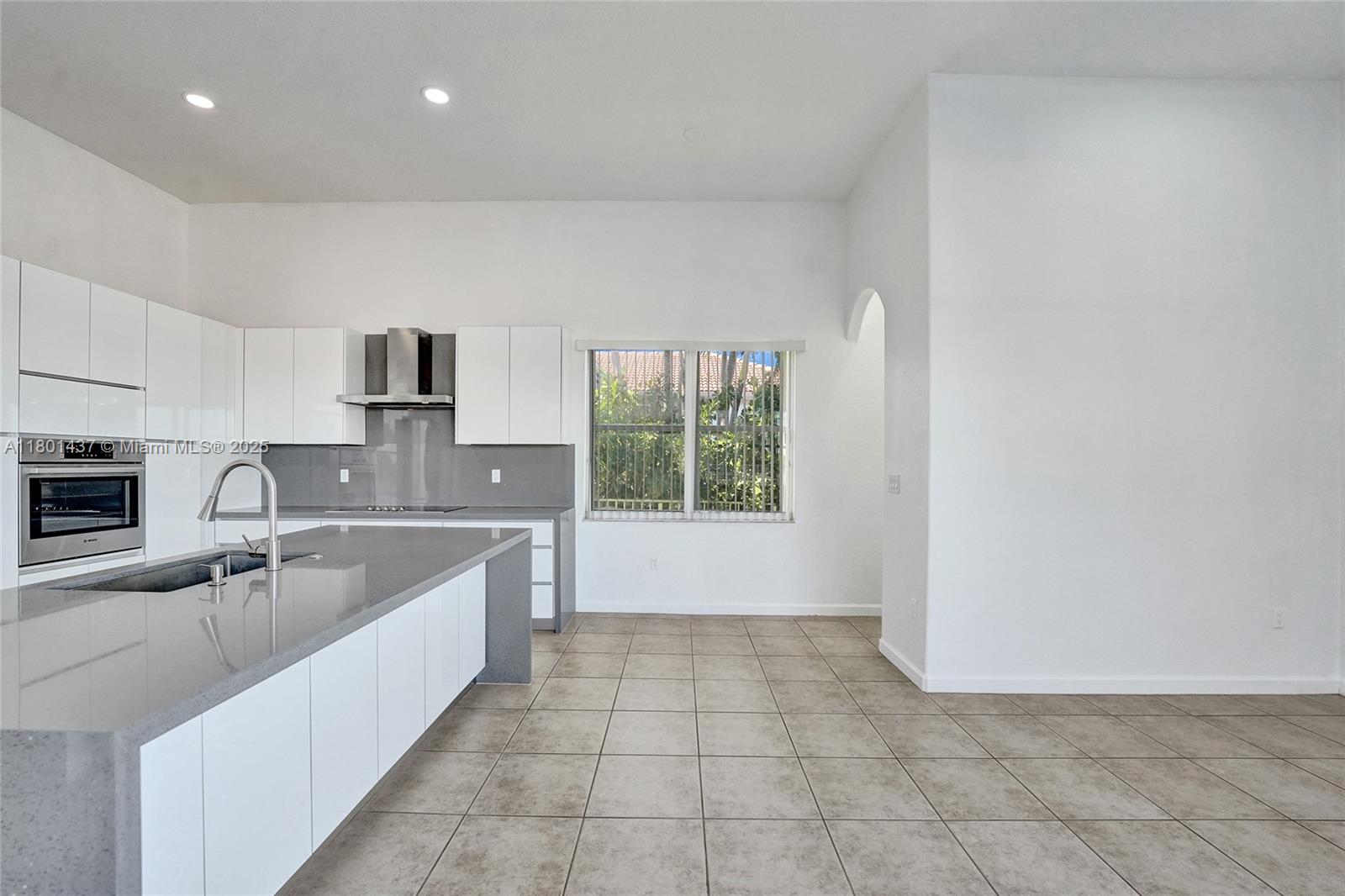 3360 Southwest 195th Terrace Miramar, FL 33029 - Photo 18 of 65 a large white kitchen with a sink and dishwasher a stove top oven with wooden floor