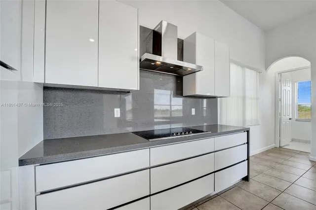 an aerial view of lake and residential houses with outdoor space