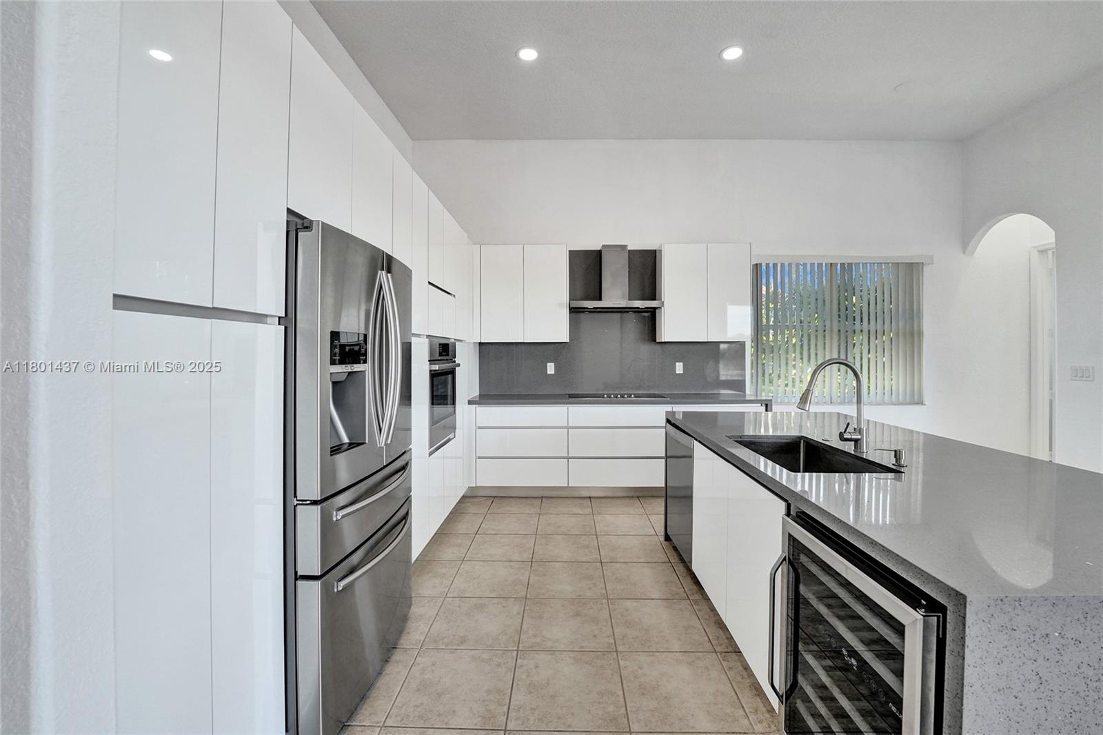 3360 Southwest 195th Terrace Miramar, FL 33029 - Photo 28 of 65 a kitchen with stainless steel appliances a sink stove and refrigerator
