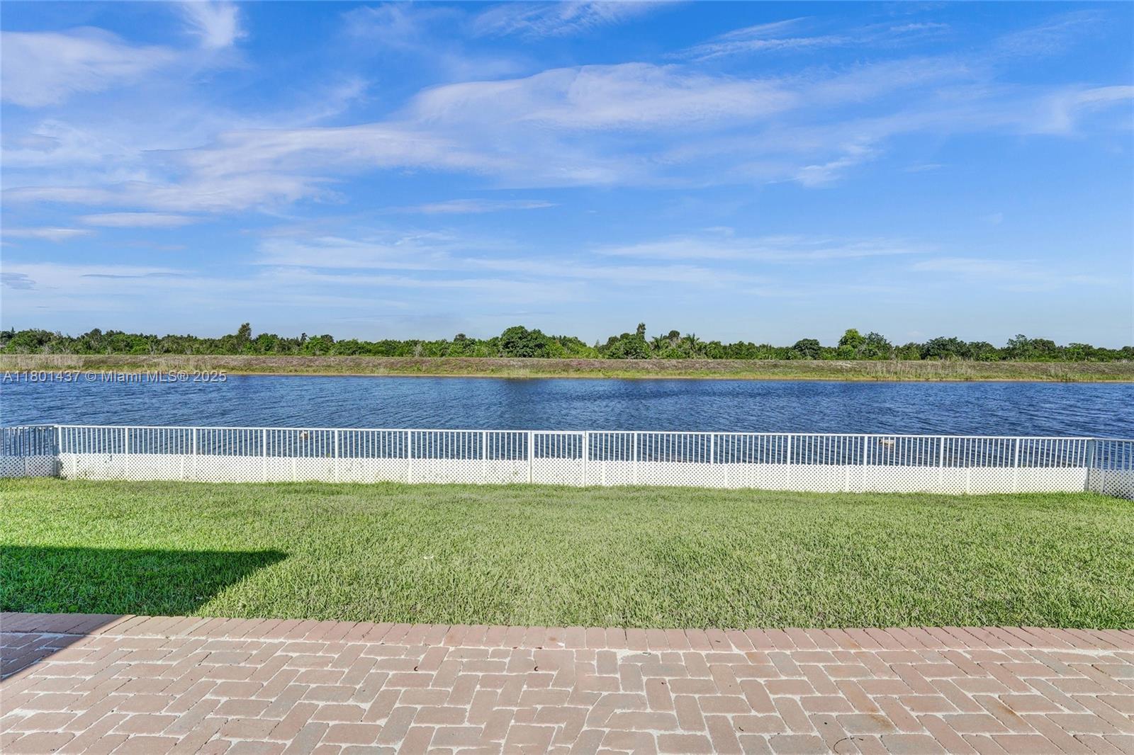3360 Southwest 195th Terrace Miramar, FL 33029 - Photo 6 of 65 a view of a lake with houses in the background