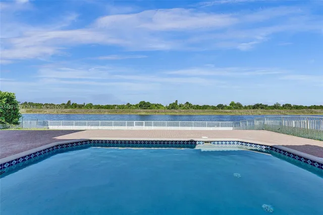 an empty room with floor to ceiling window and an outdoor view