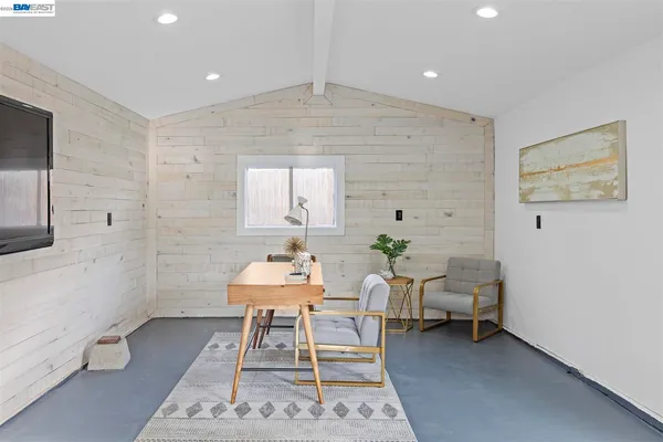 a backyard of a house with table and chairs