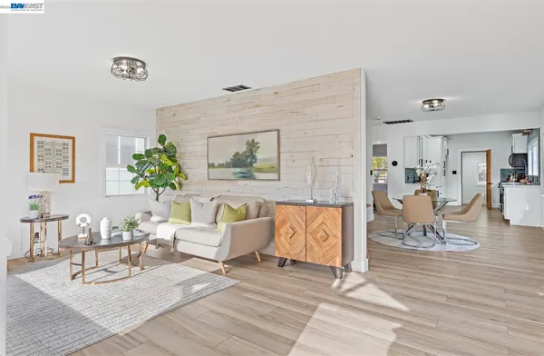 a living room with furniture and a potted plant