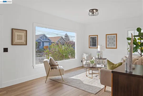 a living room with furniture a dining table and a potted plant