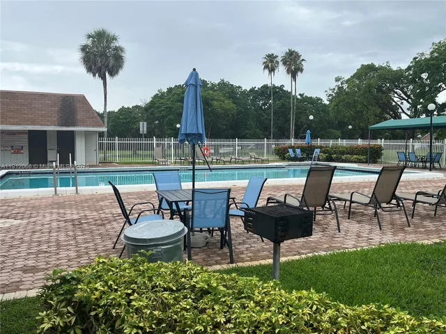 a view of a swimming pool and lounge chairs