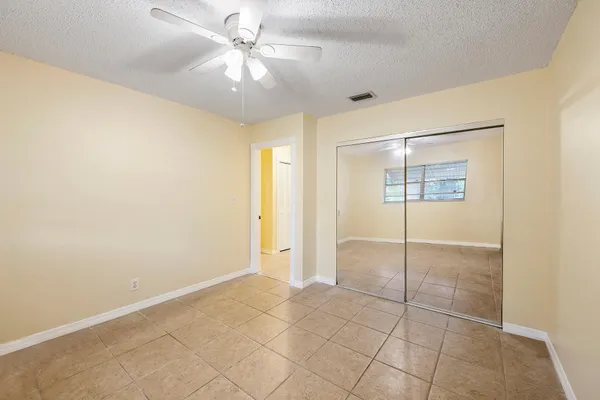 a view of an empty room with a fan