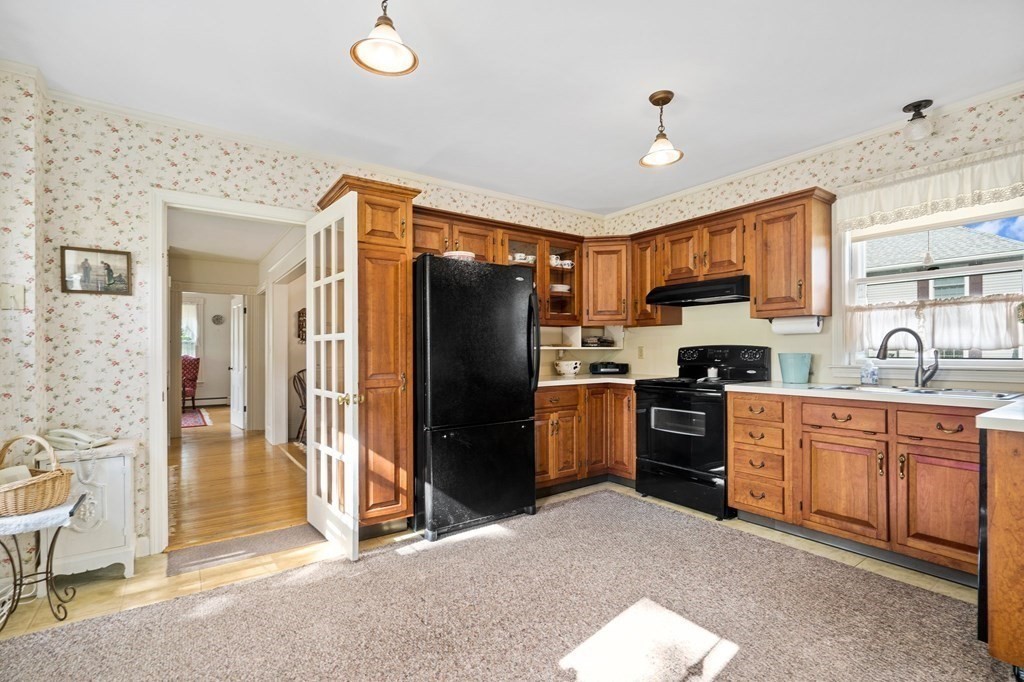 39 Summer Street Danvers, MA 01923 - Photo 13 of 46 a kitchen with granite countertop a refrigerator stove top oven and sink