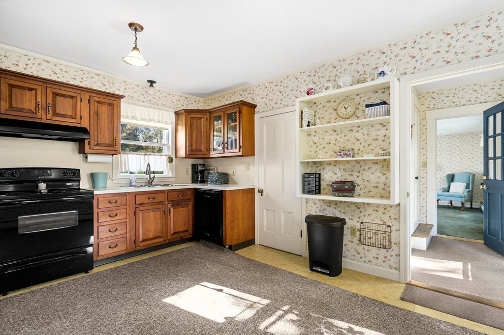 39 Summer Street Danvers, MA 01923 - Photo 14 of 46 a kitchen with stainless steel appliances granite countertop a stove a sink and a refrigerator