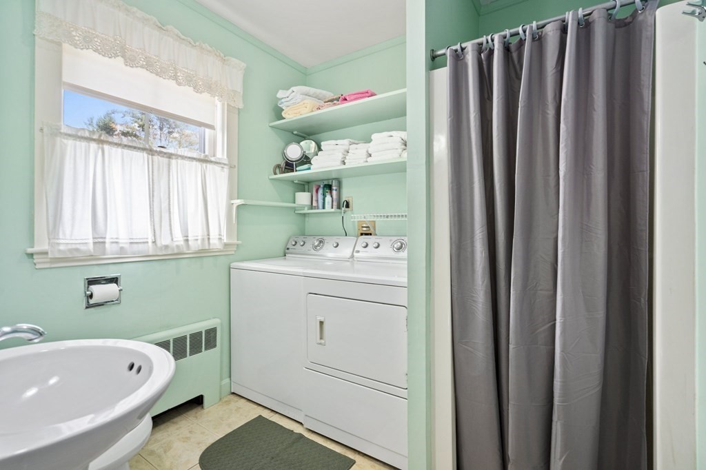 39 Summer Street Danvers, MA 01923 - Photo 16 of 46 a bathroom with a sink a bathtub and a window