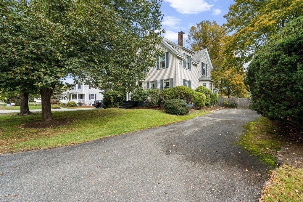 39 Summer Street Danvers, MA 01923 - Photo 2 of 46 a view of a house with a yard and large trees