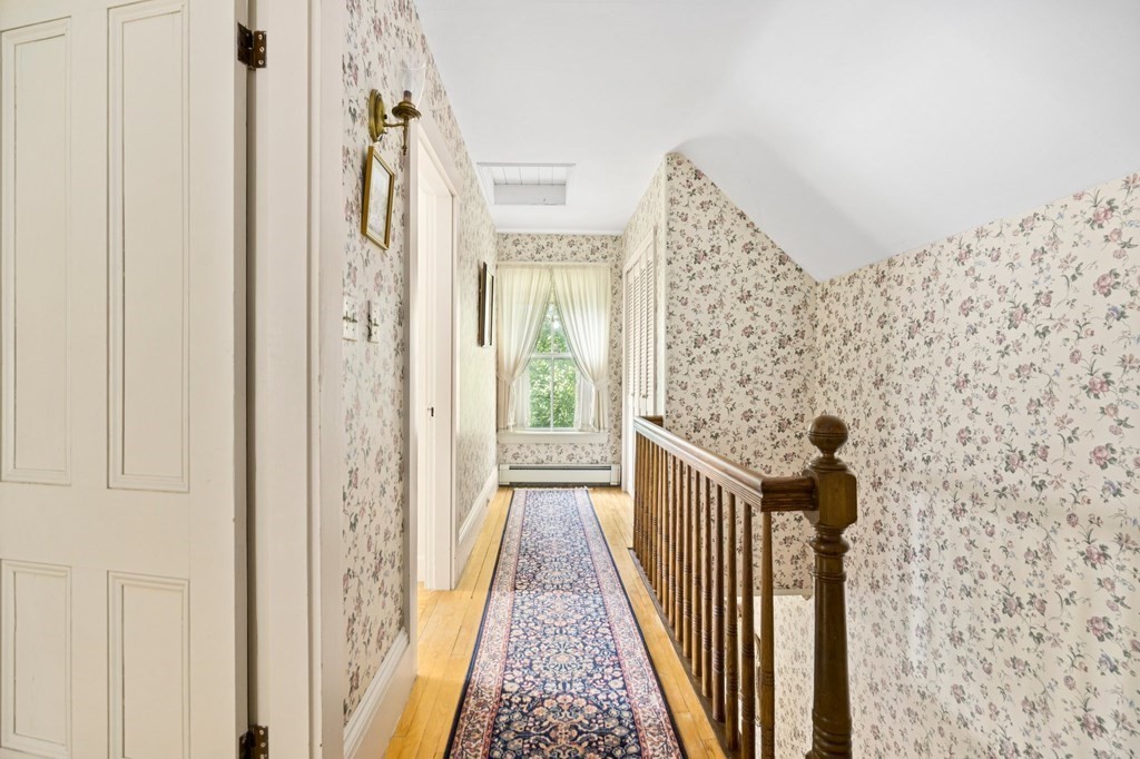 39 Summer Street Danvers, MA 01923 - Photo 21 of 46 a view of a hallway with wooden floor and staircase