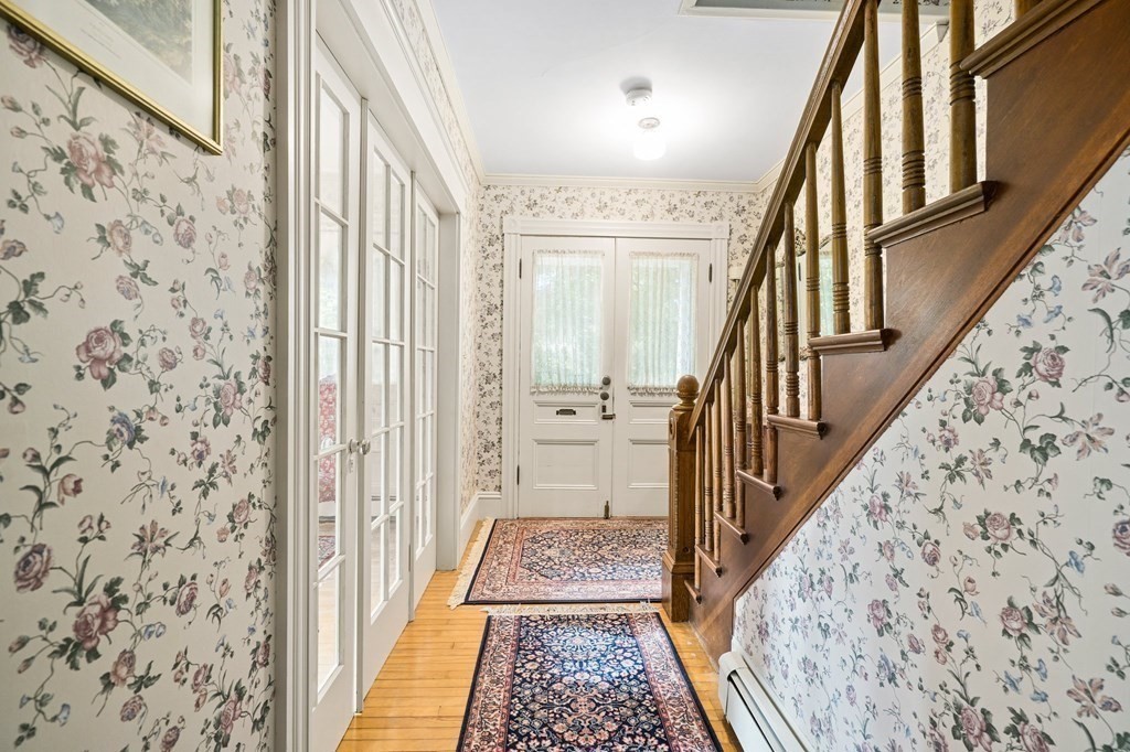 39 Summer Street Danvers, MA 01923 - Photo 4 of 46 a view of a hallway with wooden floor and staircase