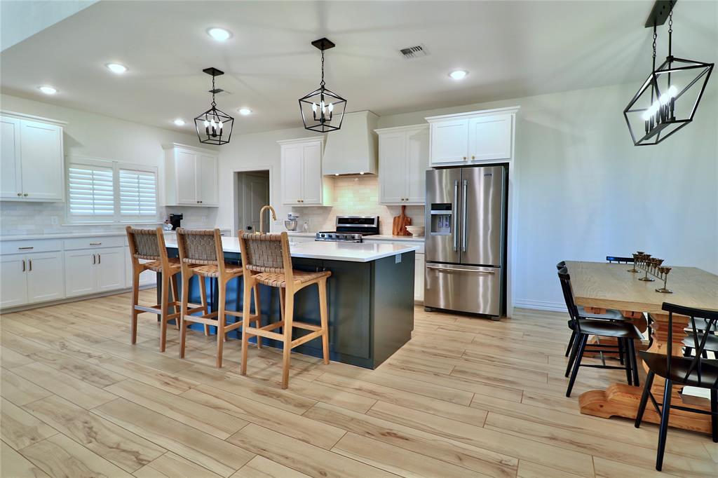 2610 Weetu Road Iowa Park, TX 76367 - Photo 11 of 35 a view of a dining room with furniture and chandelier