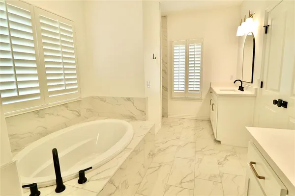 a bathroom with a tub sink and a shower