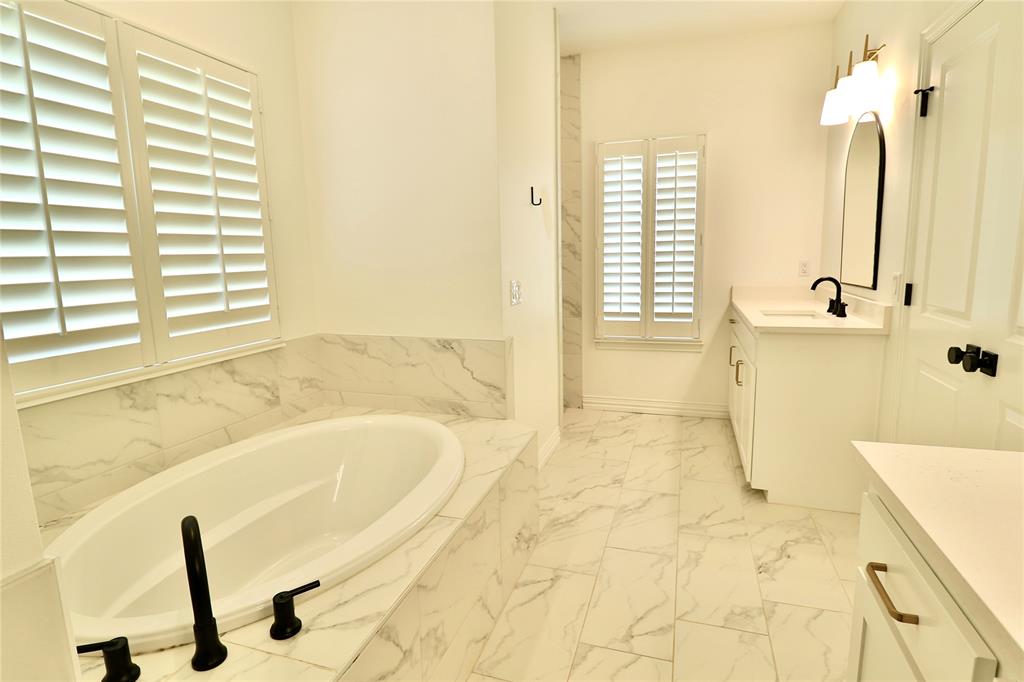 2610 Weetu Road Iowa Park, TX 76367 - Photo 16 of 35 a bathroom with a tub sink and a shower