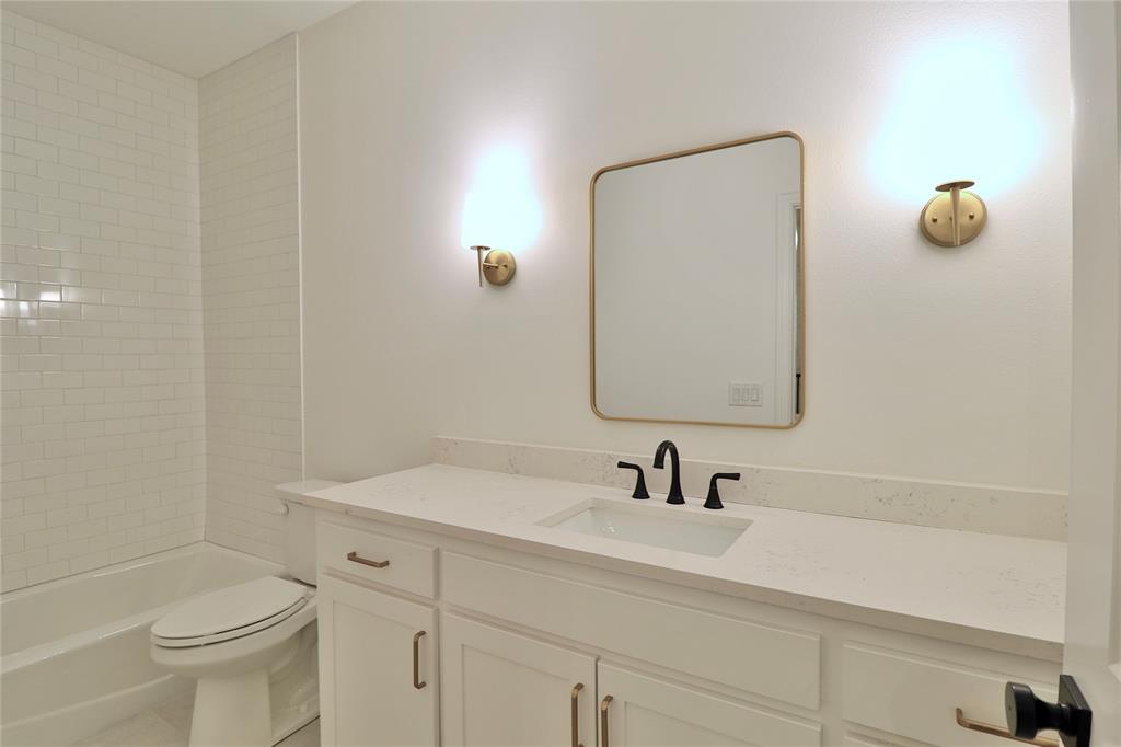 2610 Weetu Road Iowa Park, TX 76367 - Photo 18 of 35 a bathroom with a sink a toilet and shower