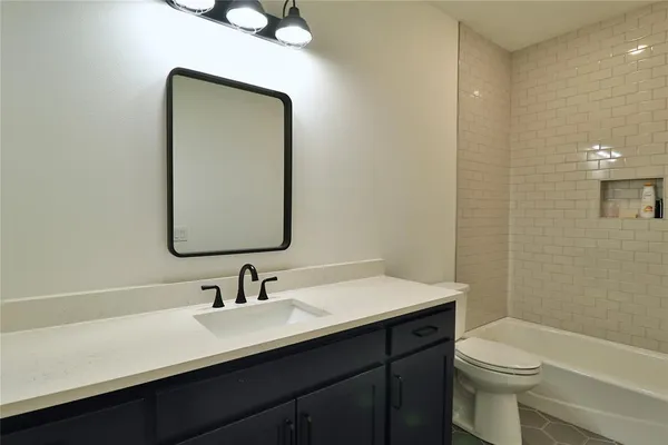a bathroom with a double vanity sink toilet and a mirror