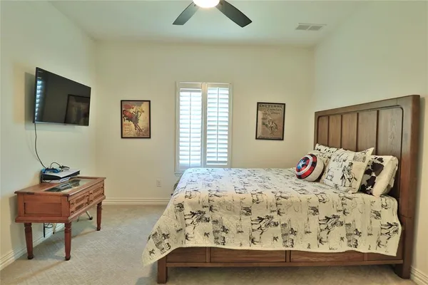 a bedroom with a bed and a tv