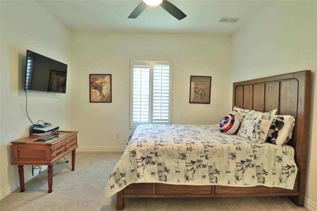 2610 Weetu Road Iowa Park, TX 76367 - Photo 20 of 35 a bedroom with a bed and a tv