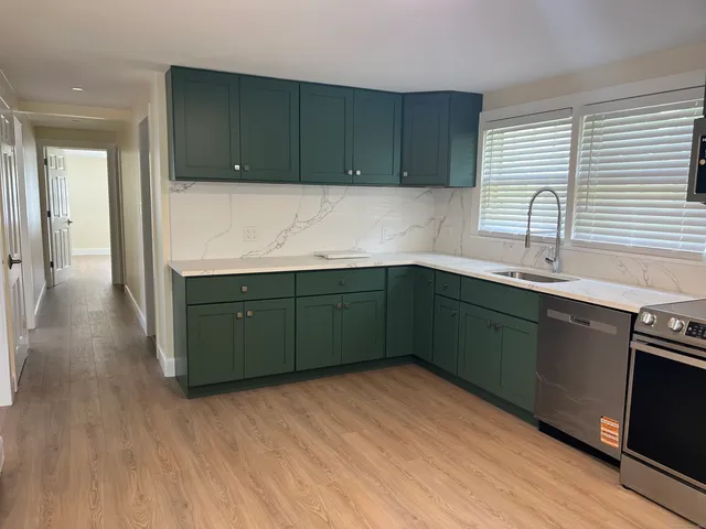 a kitchen with a sink and cabinets