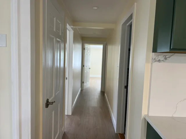 a view of a hallway with wooden floor