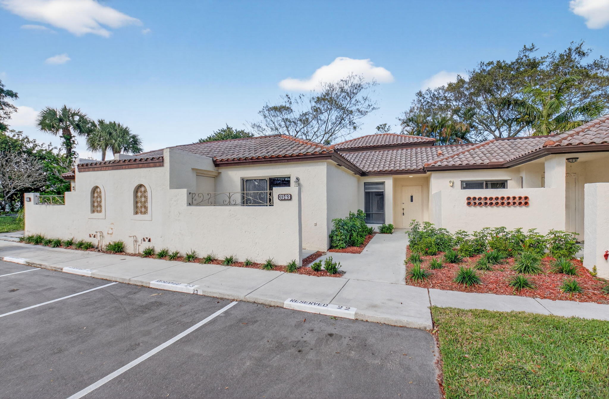 3143 Kingswood Terrace, Unit 3143 Boca Raton, FL 33431 - Photo 2 of 66 a front view of a house with a yard and a garage