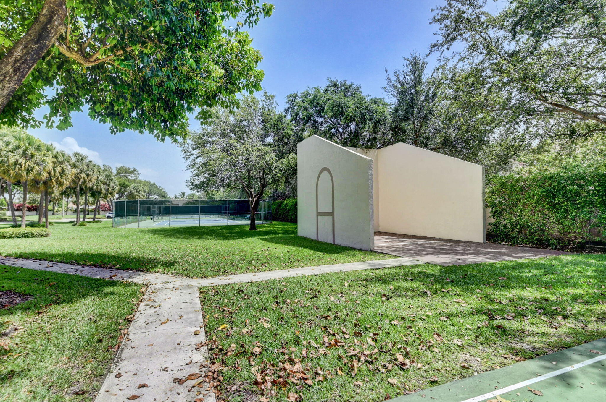 3143 Kingswood Terrace, Unit 3143 Boca Raton, FL 33431 - Photo 64 of 66 a backyard of a house with lots of green space and trees all around