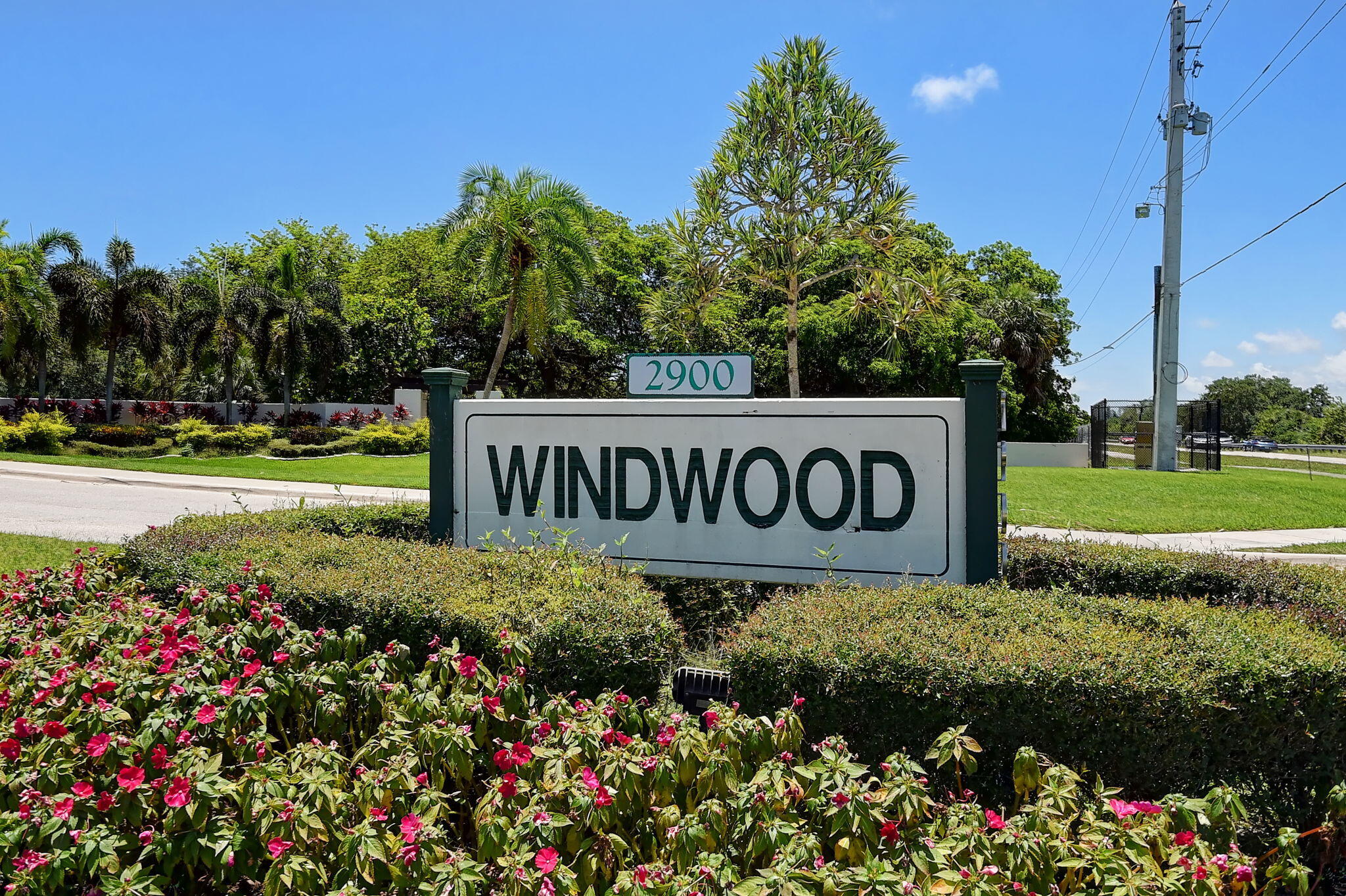 3143 Kingswood Terrace, Unit 3143 Boca Raton, FL 33431 - Photo 66 of 66 a sign that is in front of flowers