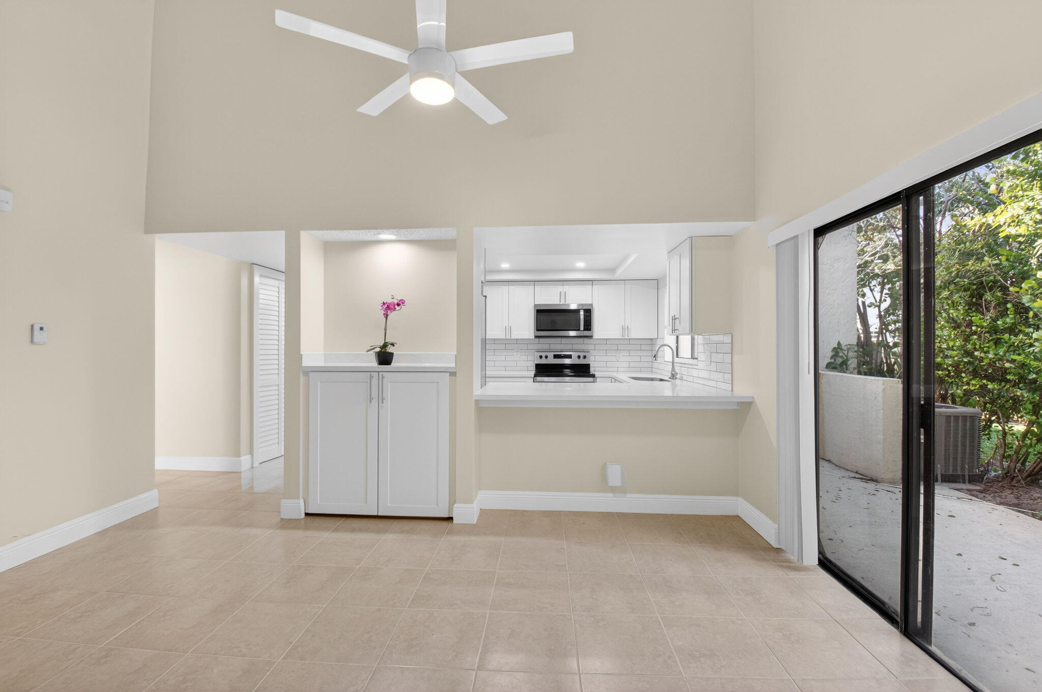 3143 Kingswood Terrace, Unit 3143 Boca Raton, FL 33431 - Photo 10 of 66 a view of a kitchen with refrigerator and window