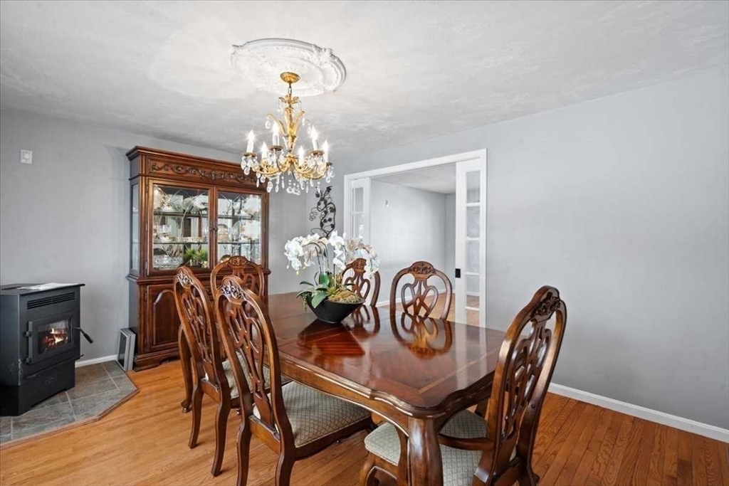 8 Wamsutta Ridge Road Charlton, MA 01507 - Photo 16 of 38 a view of a dining room with furniture a chandelier and wooden floor