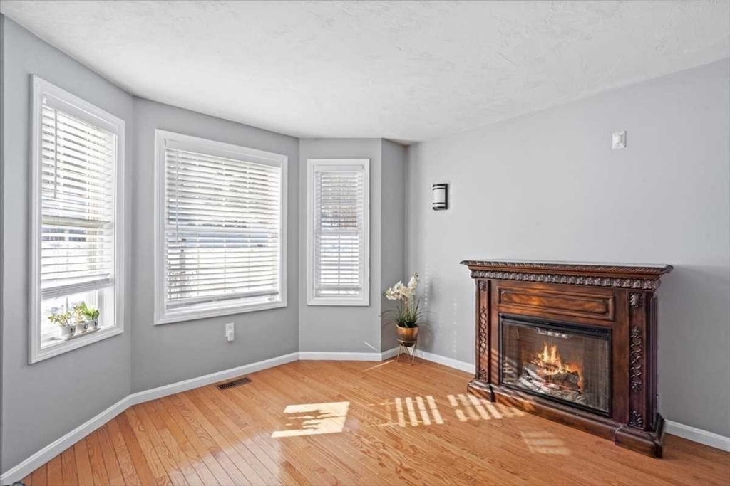 8 Wamsutta Ridge Road Charlton, MA 01507 - Photo 18 of 38 a bedroom with a bed and a fireplace