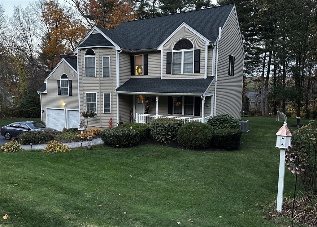 8 Wamsutta Ridge Road Charlton, MA 01507 - Photo 2 of 38 a front view of a house with a yard and garage