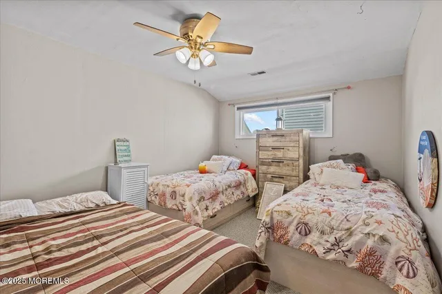 a bedroom with two beds and a chandelier