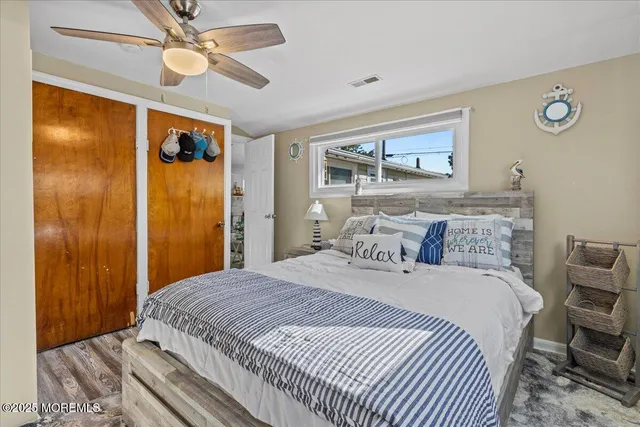 a bedroom with a large bed and a chandelier