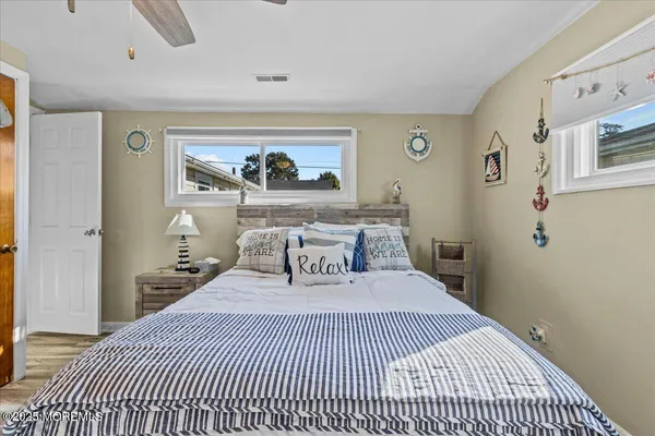 a bedroom with a large bed and a painting on the wall