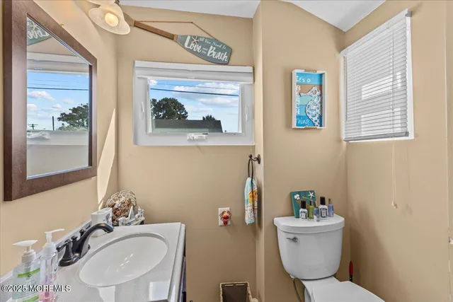 a bathroom with a sink mirror and toilet