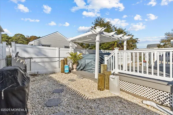 a view of a porch with a table and chairs