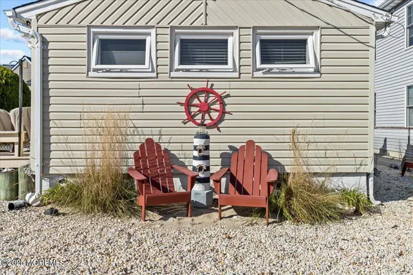 a view of a chairs and table in backyard