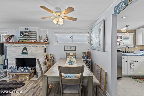 a view of a dining room with furniture a chandelier and wooden floor