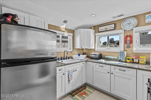 a kitchen with a sink cabinets and wooden floor