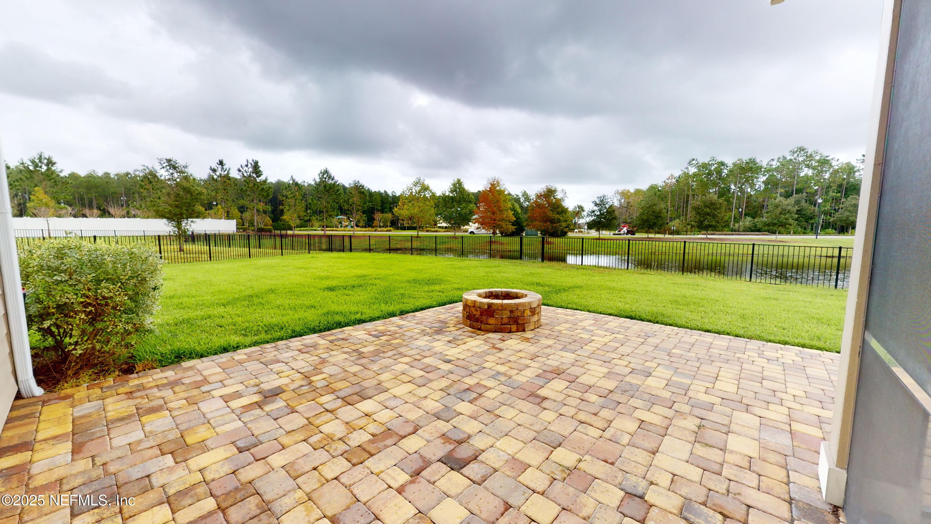 201 Silver Creek Place St. Augustine, FL 32095 - Photo 22 of 26 a view of a park with large trees and a wooden fence